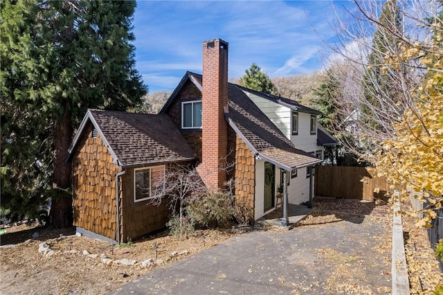 29387 Lake View Dr, Cedar Glen, CA 92321 - exterior space featuring fence, a chimney, driveway, and roof with shingles