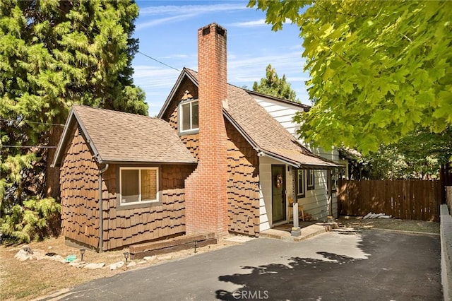 29387 Lake View Dr, Cedar Glen, CA 92321 - view of property exterior featuring roof with shingles and a chimney