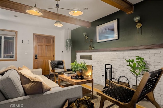 29387 Lake View Dr, Cedar Glen, CA 92321 - living area with beamed ceiling, a brick fireplace, brick wall, and wood finished floors