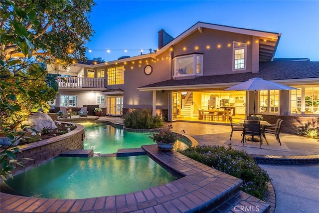 1232 Blue Gum Ln, Newport Beach, CA 92660 - rear view of house with stucco siding, a shingled roof, a pool with connected hot tub, a patio area, and a balcony