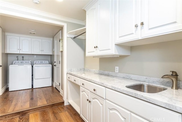 1232 Blue Gum Ln, Newport Beach, CA 92660 - laundry room with a sink, cabinet space, washing machine and dryer, dark wood-type flooring, and ornamental molding