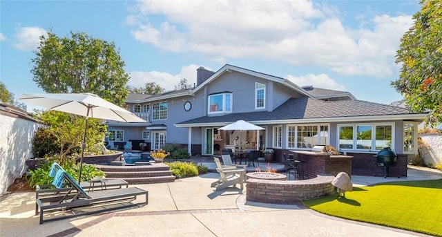 1232 Blue Gum Ln, Newport Beach, CA 92660 - back of property featuring a patio, a chimney, an outdoor fire pit, an outdoor kitchen, and stucco siding