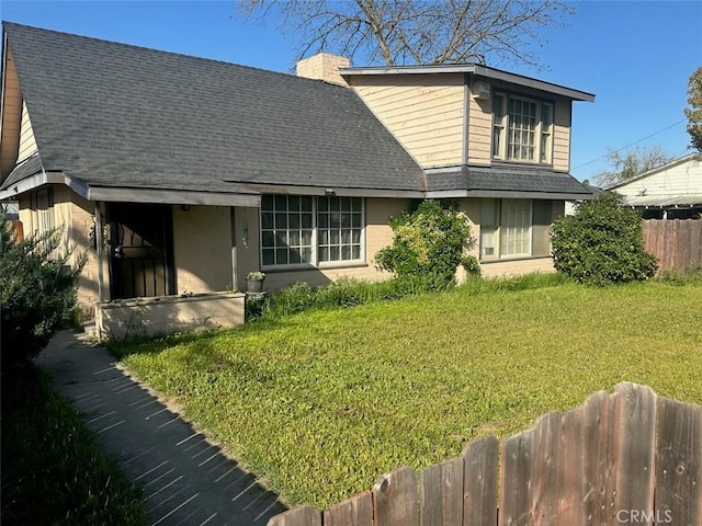 view of front of house with roof with shingles and a chimney