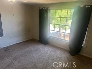 635 N 3rd St, Chowchilla, CA 93610 - carpeted spare room with plenty of natural light and baseboards