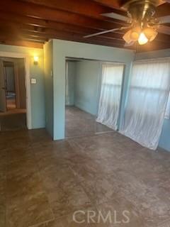 635 N 3rd St, Chowchilla, CA 93610 - unfurnished bedroom featuring a closet, ceiling fan, and beam ceiling