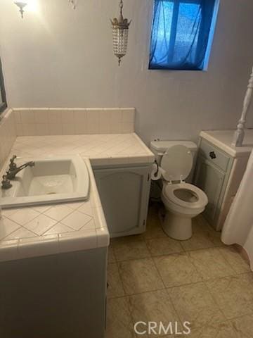 635 N 3rd St, Chowchilla, CA 93610 - bathroom with vanity, toilet, and tile patterned floors