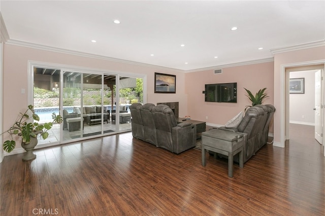 living room featuring crown molding, visible vents, and wood finished floors