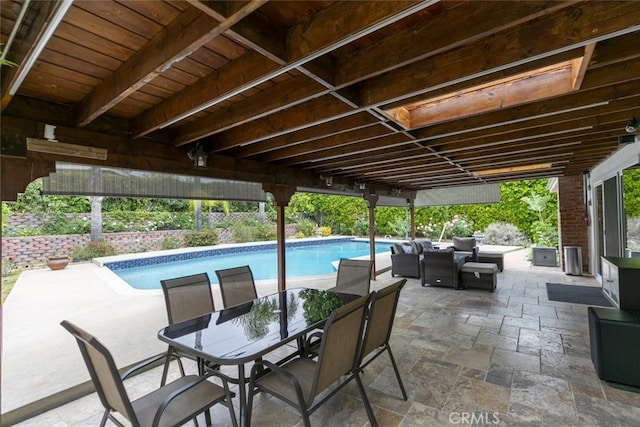 outdoor pool featuring outdoor dining area and a patio area