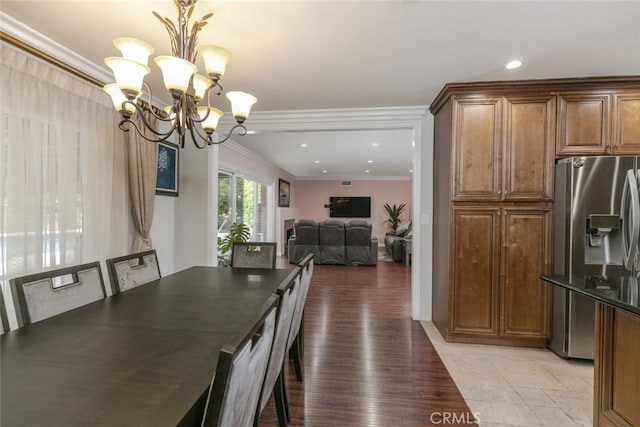 dining area with crown molding, recessed lighting, and a notable chandelier