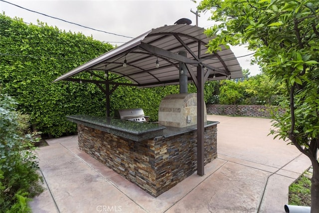 view of patio with exterior kitchen and area for grilling