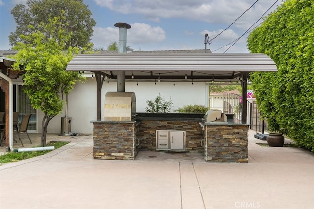 view of patio / terrace featuring fence, grilling area, a gazebo, and area for grilling
