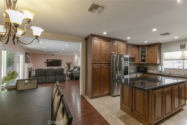 kitchen with stainless steel fridge, a healthy amount of sunlight, a sink, and visible vents