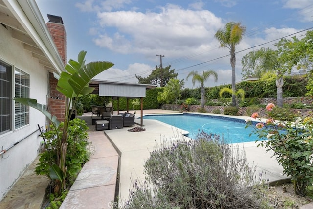 outdoor pool with a patio and an outdoor living space
