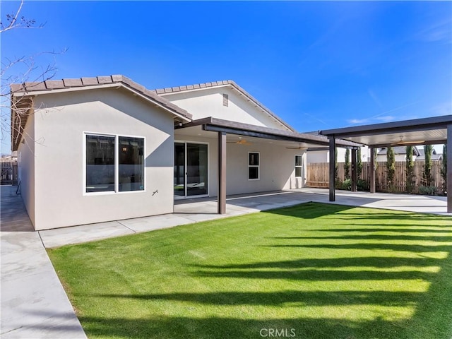 5211 Wingspan Ln, Bakersfield, CA 93306 - back of house with a patio, fence, stucco siding, and a lawn