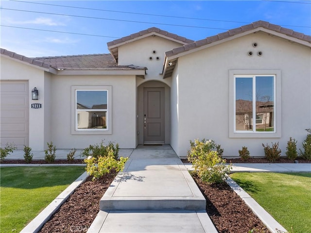 5211 Wingspan Ln, Bakersfield, CA 93306 - view of front of property featuring a front yard, stucco siding, and a tiled roof