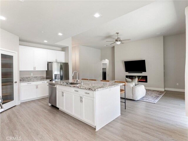 5211 Wingspan Ln, Bakersfield, CA 93306 - kitchen featuring appliances with stainless steel finishes, light wood-type flooring, a ceiling fan, and a sink