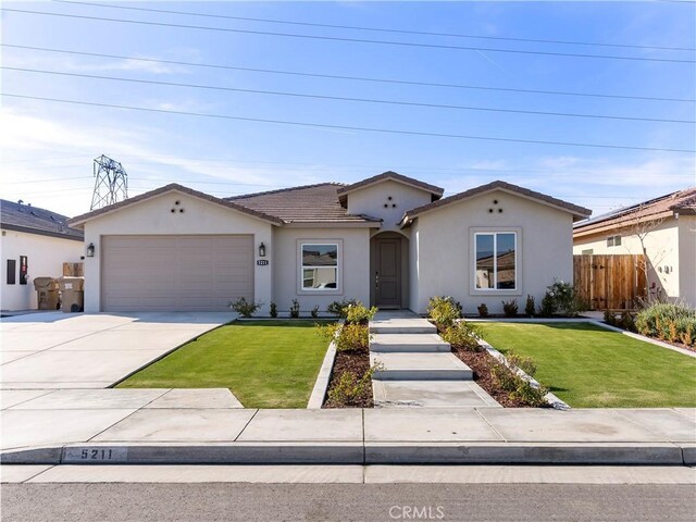 5211 Wingspan Ln, Bakersfield, CA 93306 - single story home with stucco siding, fence, a garage, a front lawn, and concrete driveway