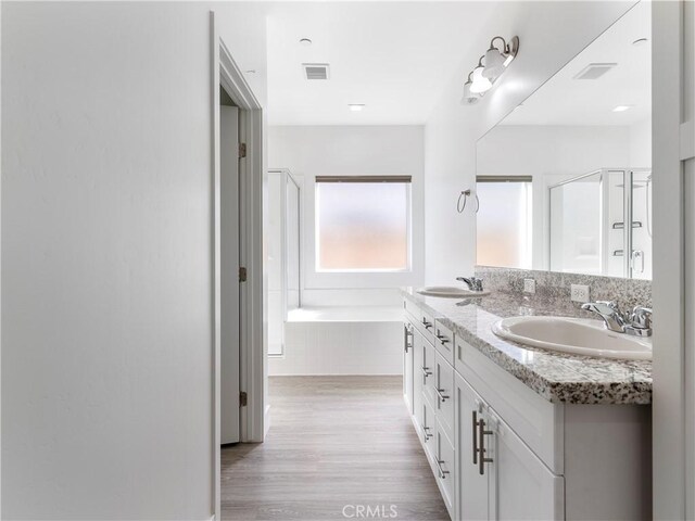 5211 Wingspan Ln, Bakersfield, CA 93306 - full bath featuring wood finished floors, visible vents, a shower stall, and a sink