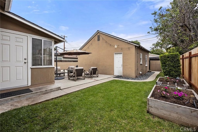1229 Central Ave, Fullerton, CA 92831 - rear view of property featuring a vegetable garden, stucco siding, and a patio area