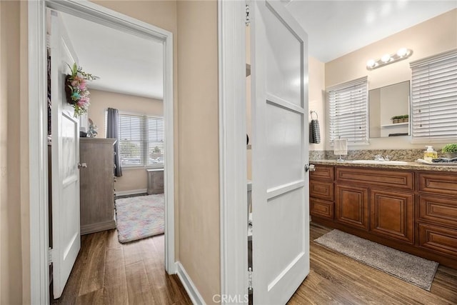1229 Central Ave, Fullerton, CA 92831 - bathroom featuring wood finished floors, vanity, and baseboards