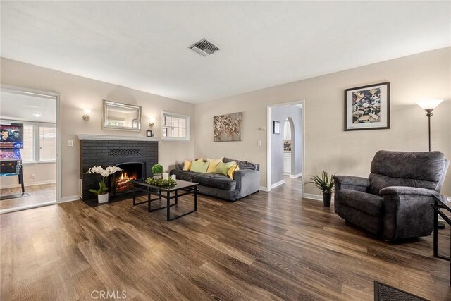 1229 Central Ave, Fullerton, CA 92831 - living room featuring a fireplace, dark wood finished floors, healthy amount of natural light, and baseboards