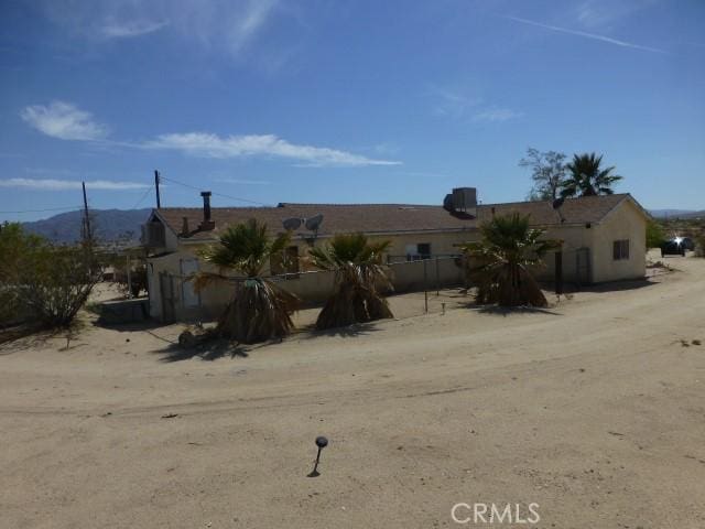 3465 Condor Rd Unit 29, Palms, CA 92277 - view of front facade featuring a mountain view and fence