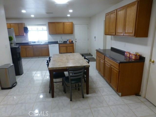 3465 Condor Rd Unit 29, Palms, CA 92277 - kitchen with brown cabinets, recessed lighting, dark countertops, a sink, and white dishwasher