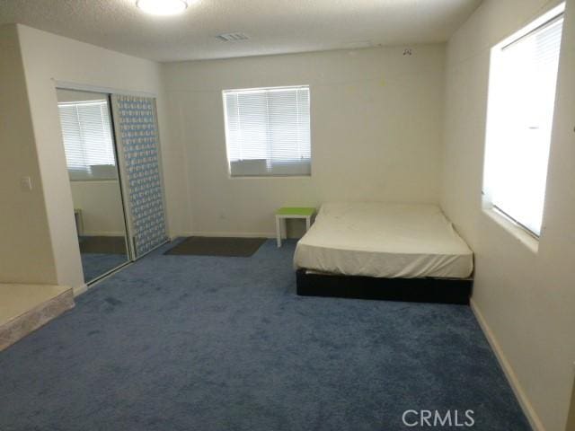3465 Condor Rd Unit 29, Palms, CA 92277 - bedroom with baseboards, carpet flooring, multiple windows, and visible vents
