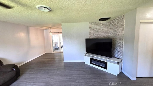 unfurnished living room featuring wood finished floors, a fireplace, and a textured ceiling