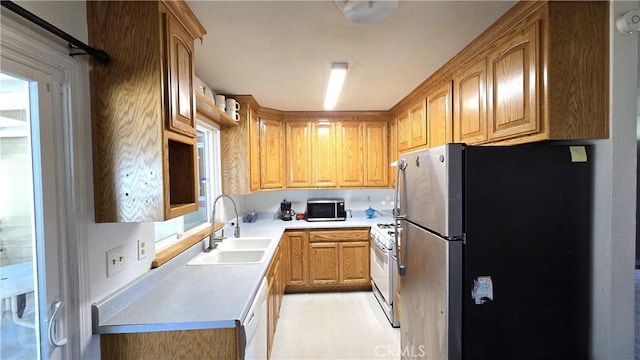 kitchen featuring light countertops, stainless steel appliances, and a sink