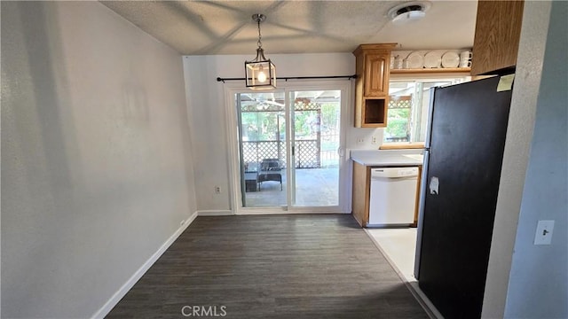 kitchen with dark wood-style floors, dishwasher, freestanding refrigerator, baseboards, and a textured ceiling