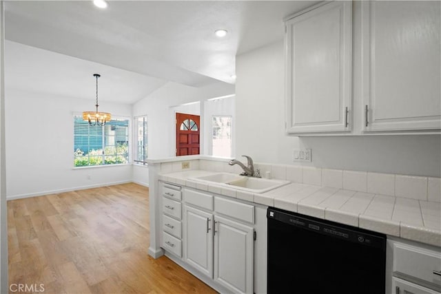 kitchen with black dishwasher, a sink, light wood-style floors, white cabinets, and a chandelier
