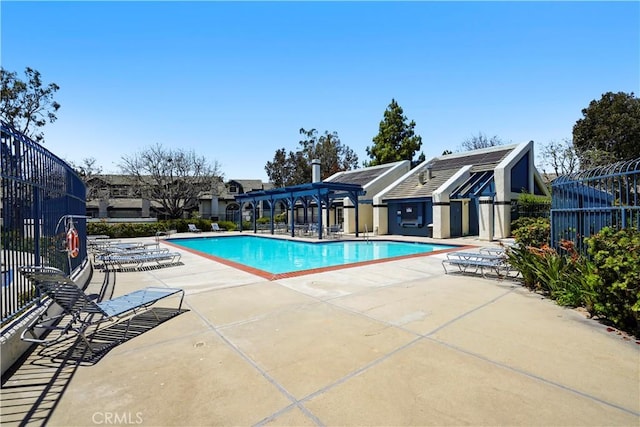 community pool with fence and a patio