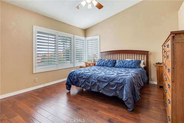 bedroom with baseboards, wood finished floors, and lofted ceiling