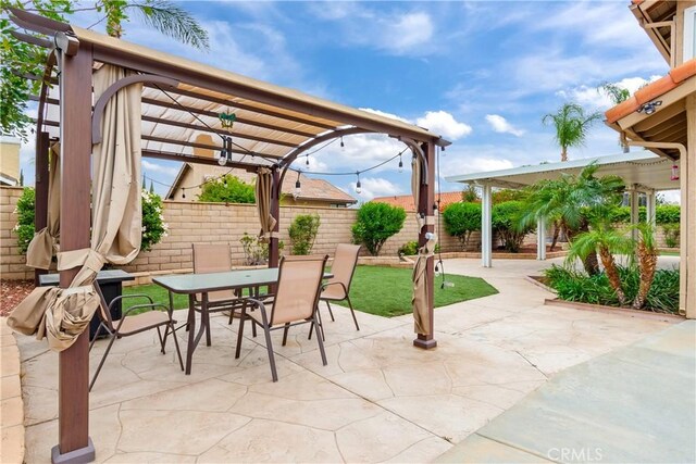 view of patio / terrace featuring a fenced backyard, a pergola, and outdoor dining space