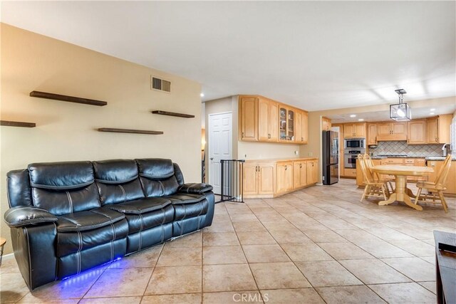 living room with visible vents, recessed lighting, and light tile patterned floors