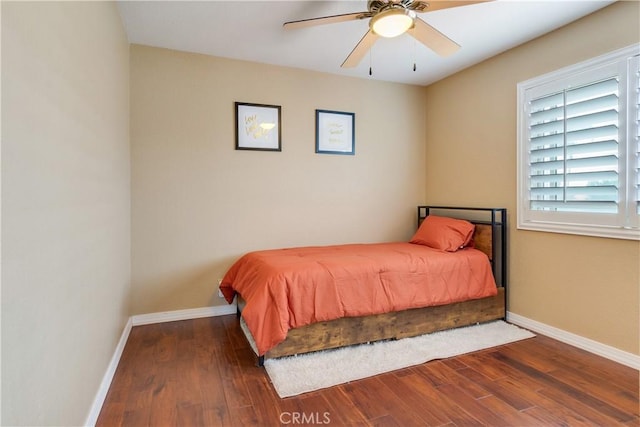 bedroom with a ceiling fan, baseboards, and wood finished floors