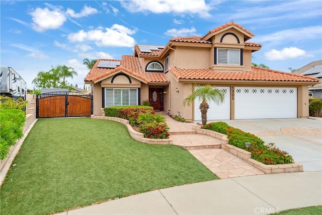 mediterranean / spanish home with a gate, stucco siding, driveway, and a front lawn
