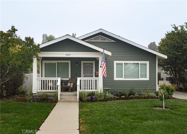 bungalow-style house featuring a porch and a front yard
