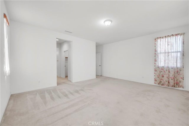 empty room featuring visible vents and carpet floors