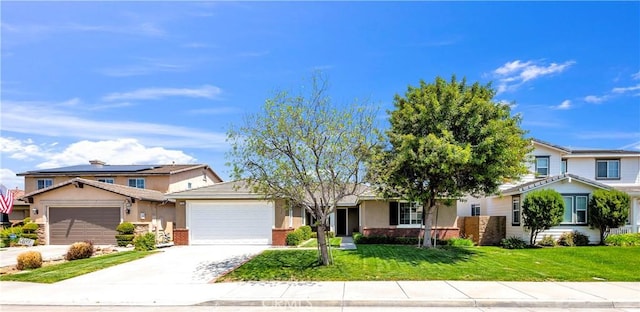 view of front of house with a front yard, driveway, an attached garage, and stucco siding