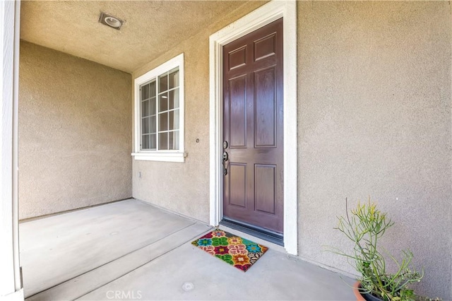 doorway to property with stucco siding