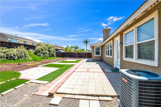 view of patio with cooling unit and a fenced backyard
