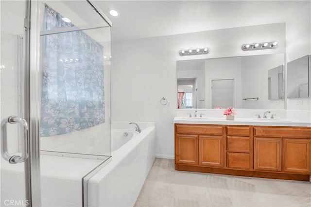 bathroom featuring a stall shower, double vanity, a bath, and a sink