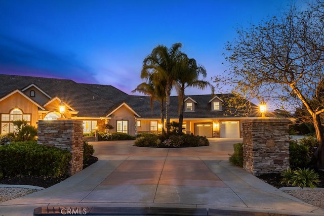 25032 Trilogy Trail Ln, Murrieta, CA 92562 - view of front of property featuring curved driveway and stone siding