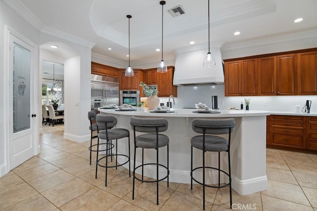 25032 Trilogy Trail Ln, Murrieta, CA 92562 - kitchen with stainless steel appliances, ornamental molding, light tile patterned flooring, and a kitchen bar