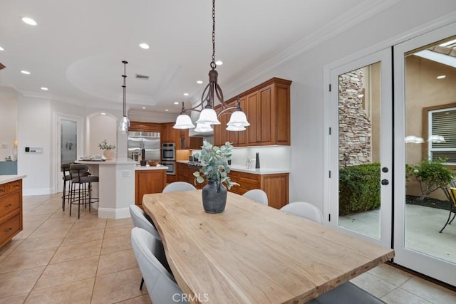 25032 Trilogy Trail Ln, Murrieta, CA 92562 - dining area with crown molding, light tile patterned flooring, recessed lighting, and a raised ceiling