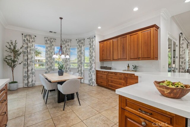 25032 Trilogy Trail Ln, Murrieta, CA 92562 - kitchen with light countertops, brown cabinetry, light tile patterned flooring, and visible vents