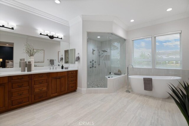 25032 Trilogy Trail Ln, Murrieta, CA 92562 - bathroom featuring vanity, crown molding, a stall shower, and a soaking tub