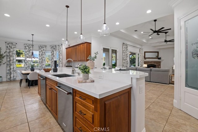 25032 Trilogy Trail Ln, Murrieta, CA 92562 - kitchen with a sink, brown cabinetry, ceiling fan with notable chandelier, recessed lighting, and light tile patterned floors